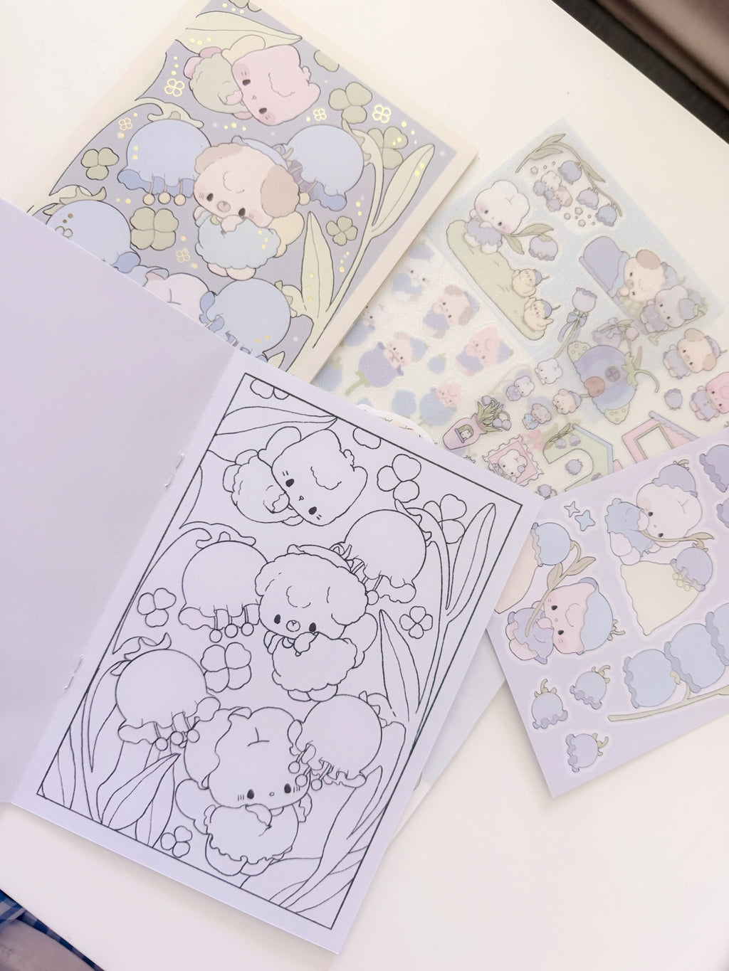 Set of cute animal-themed stickers and coloring pages on a white surface