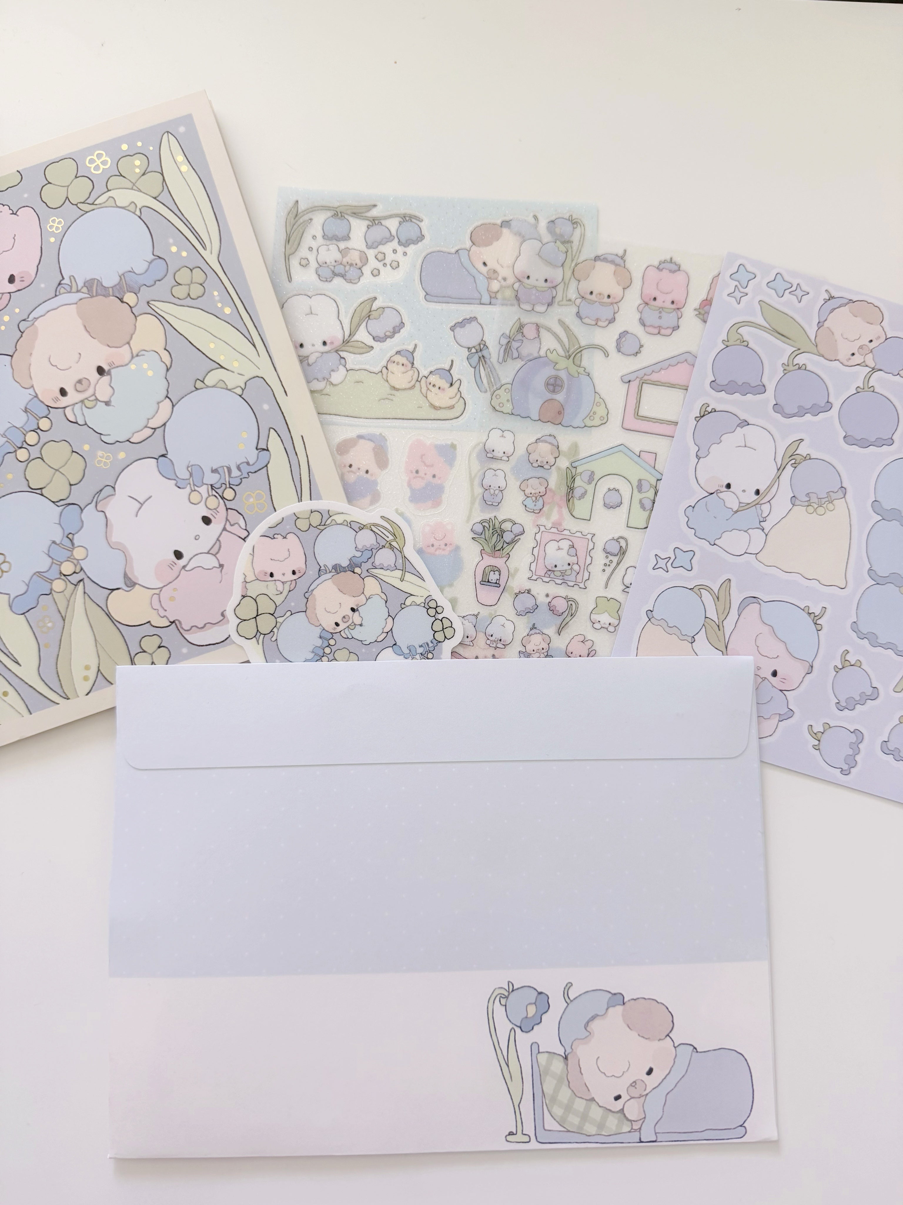 Set of stationery items with cute animal illustrations on a white background