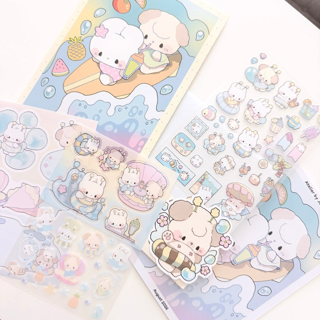 A collection of cute pastel sticker sheets featuring cartoon animal characters in a beach-themed illustration, arranged on a white surface.